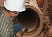 a Rand employee inspecting a sewer line
