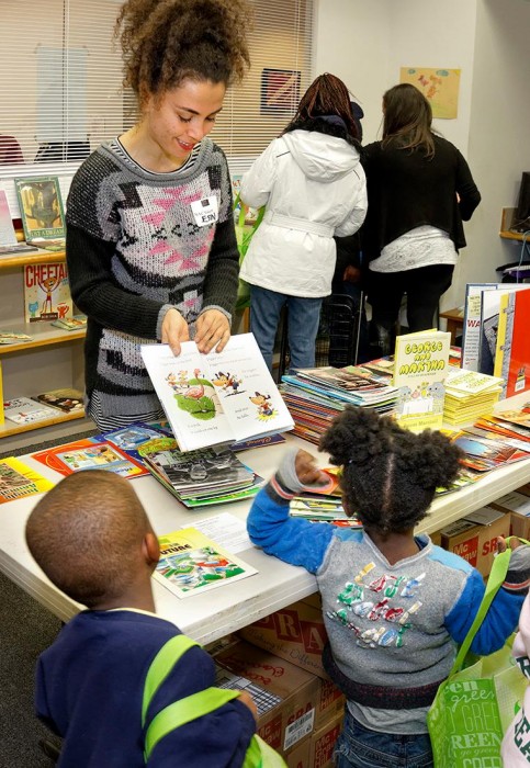 Project Associate Esin Pektas and the children partake in the joy of reading at the NAC Book Fair this Fall.