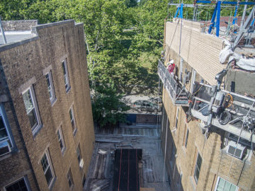 Parkside Association roof and parapet wall replacement in process. Shown: original facade of the east wing of the building (left) and the newly constructed parapet wall of the west wing (right).