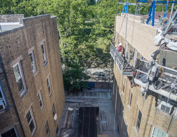 Parkside Association roof and parapet wall replacement in process. Shown: original facade of the east wing of the building (left) and the newly constructed parapet wall of the west wing (right).