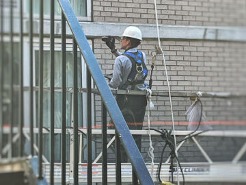 Documenting conditions during a hands-on Facade Inspection Safety Program examination.
