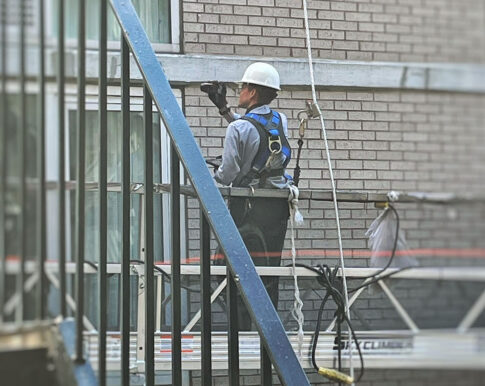 Documenting conditions during a hands-on Facade Inspection Safety Program examination.