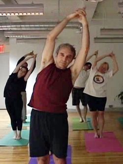 Stretch Relief: RAND's President Stephen Varone and coworkers work it out at the firm's on-site yoga class.