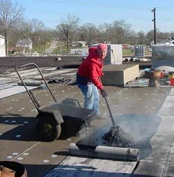 applying hot asphalt to a roof