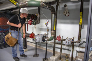 RAND Engineer inspects gas piping system.