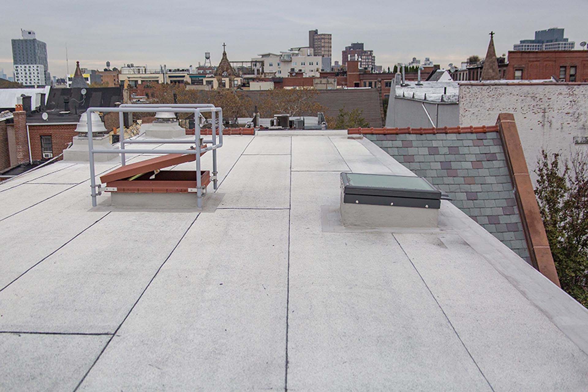 <p>As part of the program, the entire existing roofing system was removed and replaced with a new insulated cold fluid-applied reinforced roofing system and an all new slate roofing system.</p>
