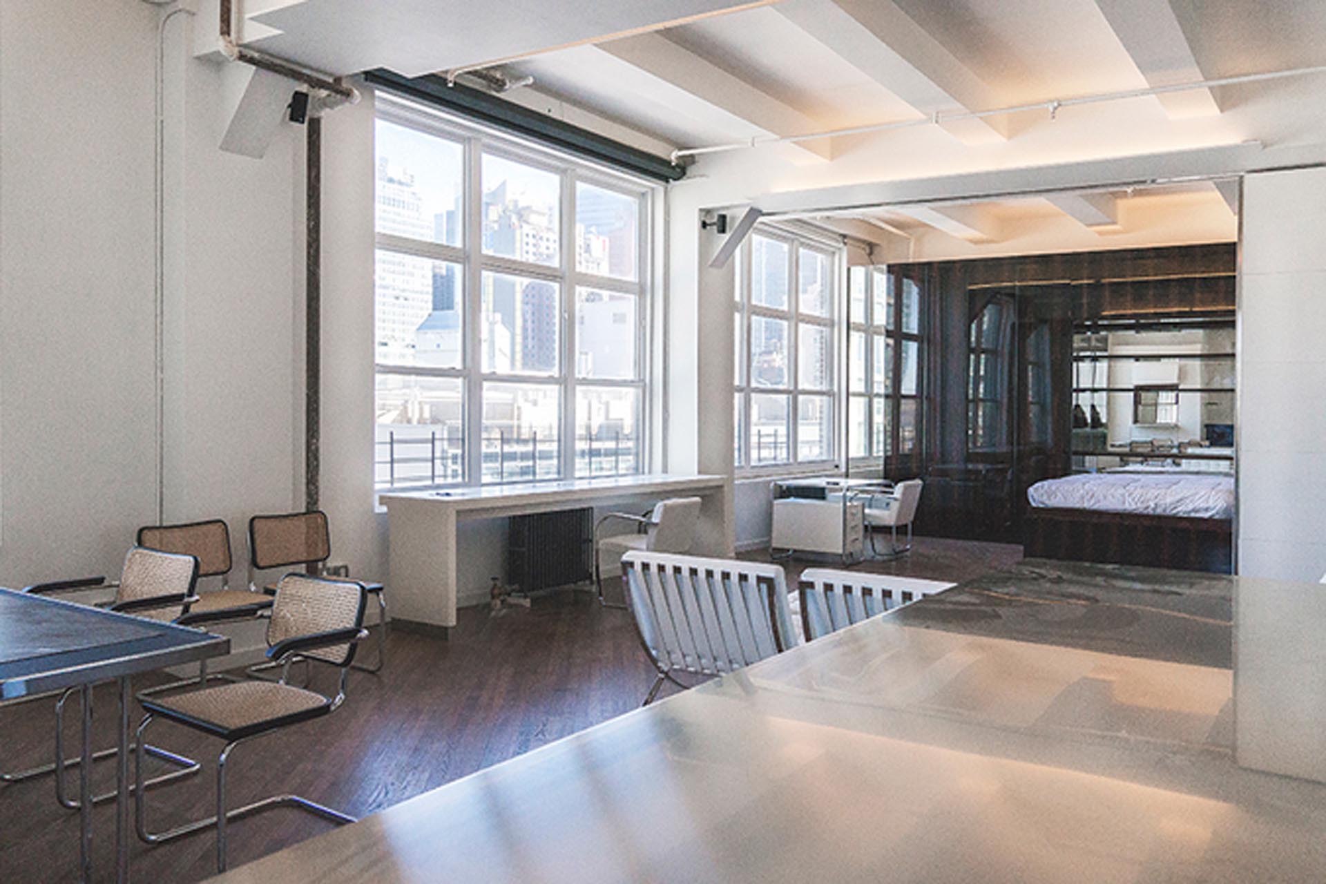 <p>The open-concept apartment renovation features two bedrooms with Murphy beds and seamlessly built-in storage separated from the main living area by sliding walls.</p>
