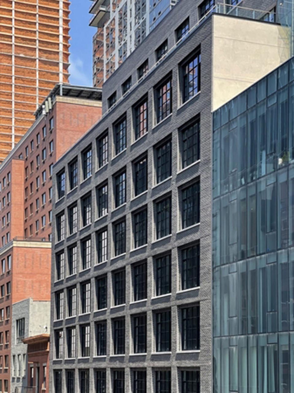 <p>Completed out-of-ground construction at 517 West 29th Street – HXH Residences, a 1 0-story, 60-unit condominium featuring a dark-colored brick facade and industrial-style windows.</p>
