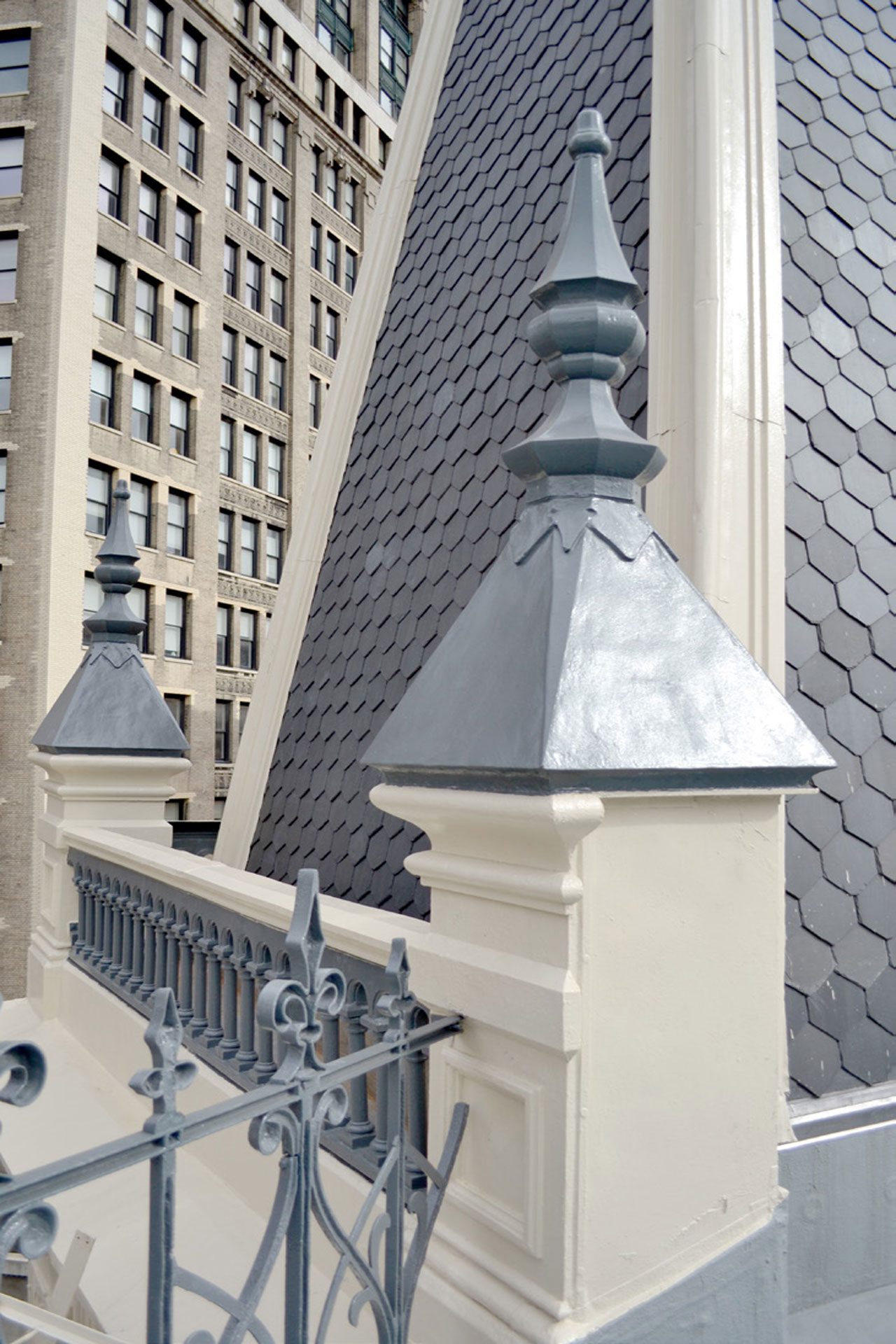 <p>The original slate shingles on the mansard roof were reinstalled wherever possible. The finials were restored, or replaced where missing with fiberglass replicas.</p>
