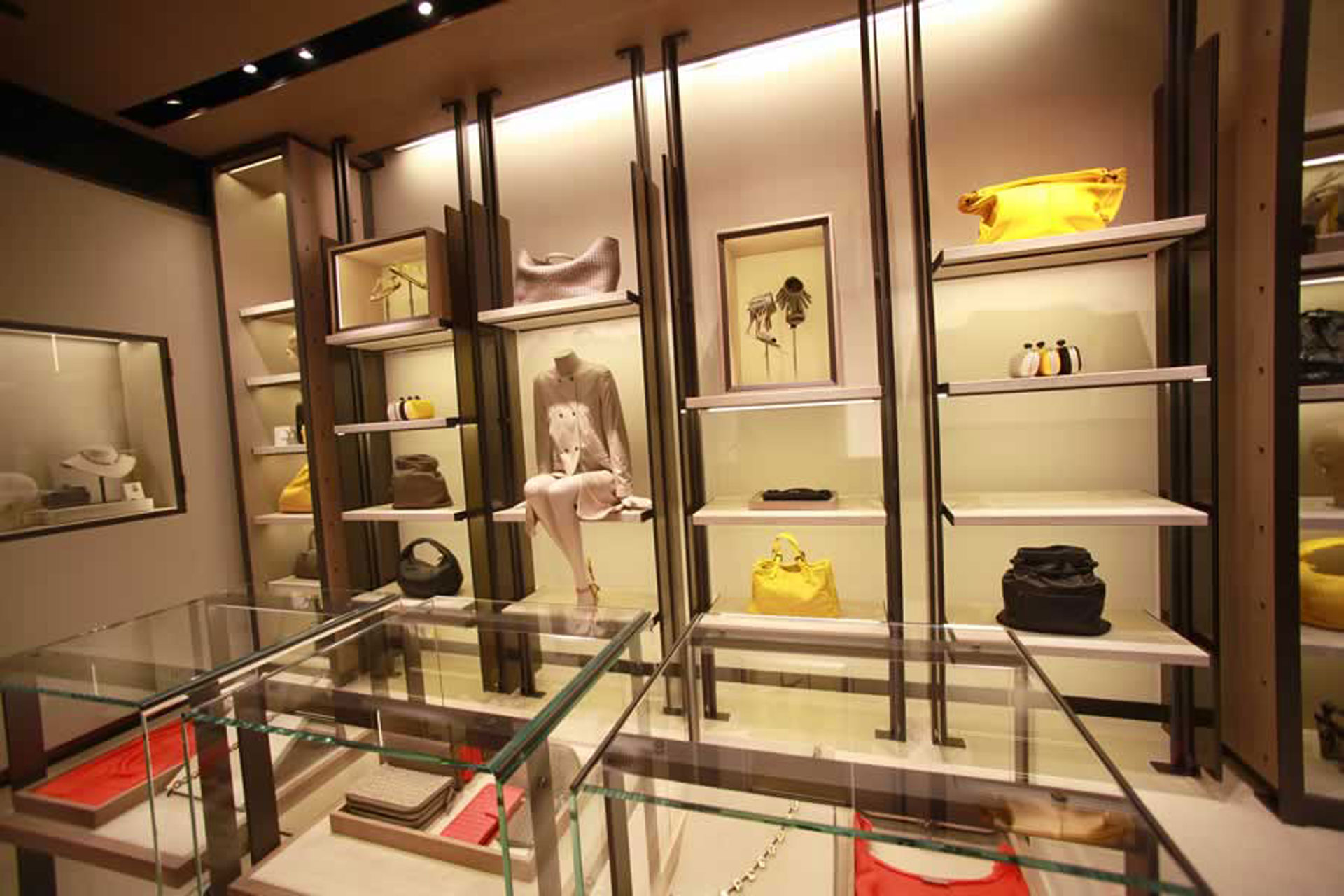 <p>The store features hand-crafted cabinets and bronze-tinted glass.</p>
