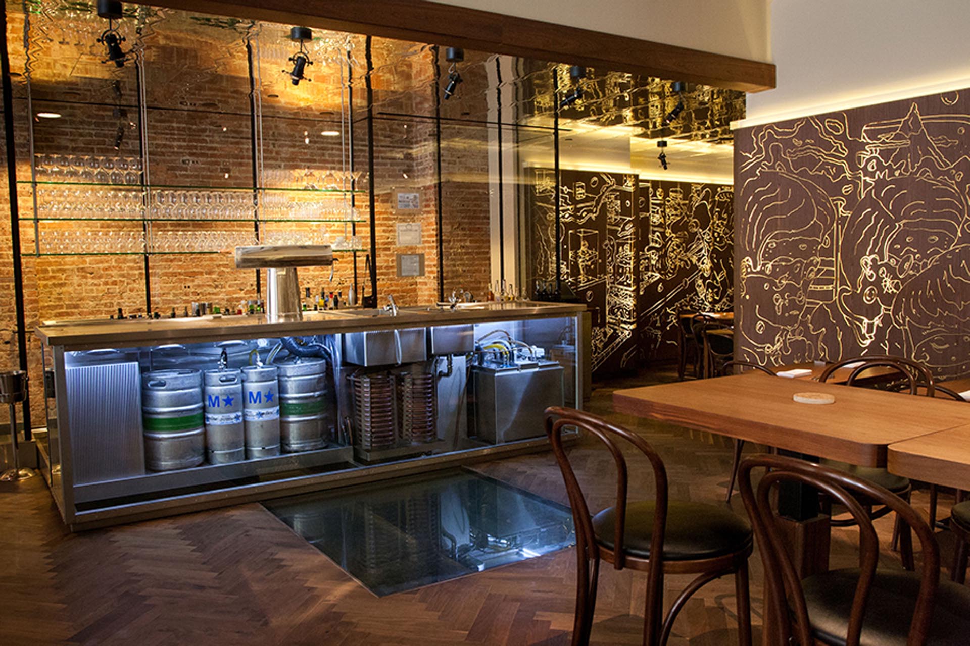 <p>A glass panel in the floor provides a view of wine and beer stored in the cellar.</p>
