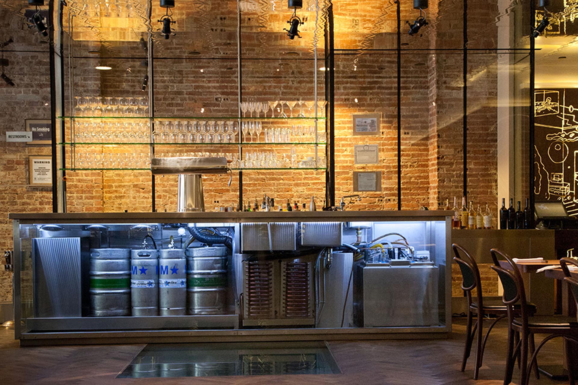 <p>Hospoda features a brushed-steel frame glass bar that displays kegs of beer.</p>

