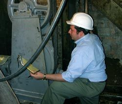 A Rand Employee doing a building survey