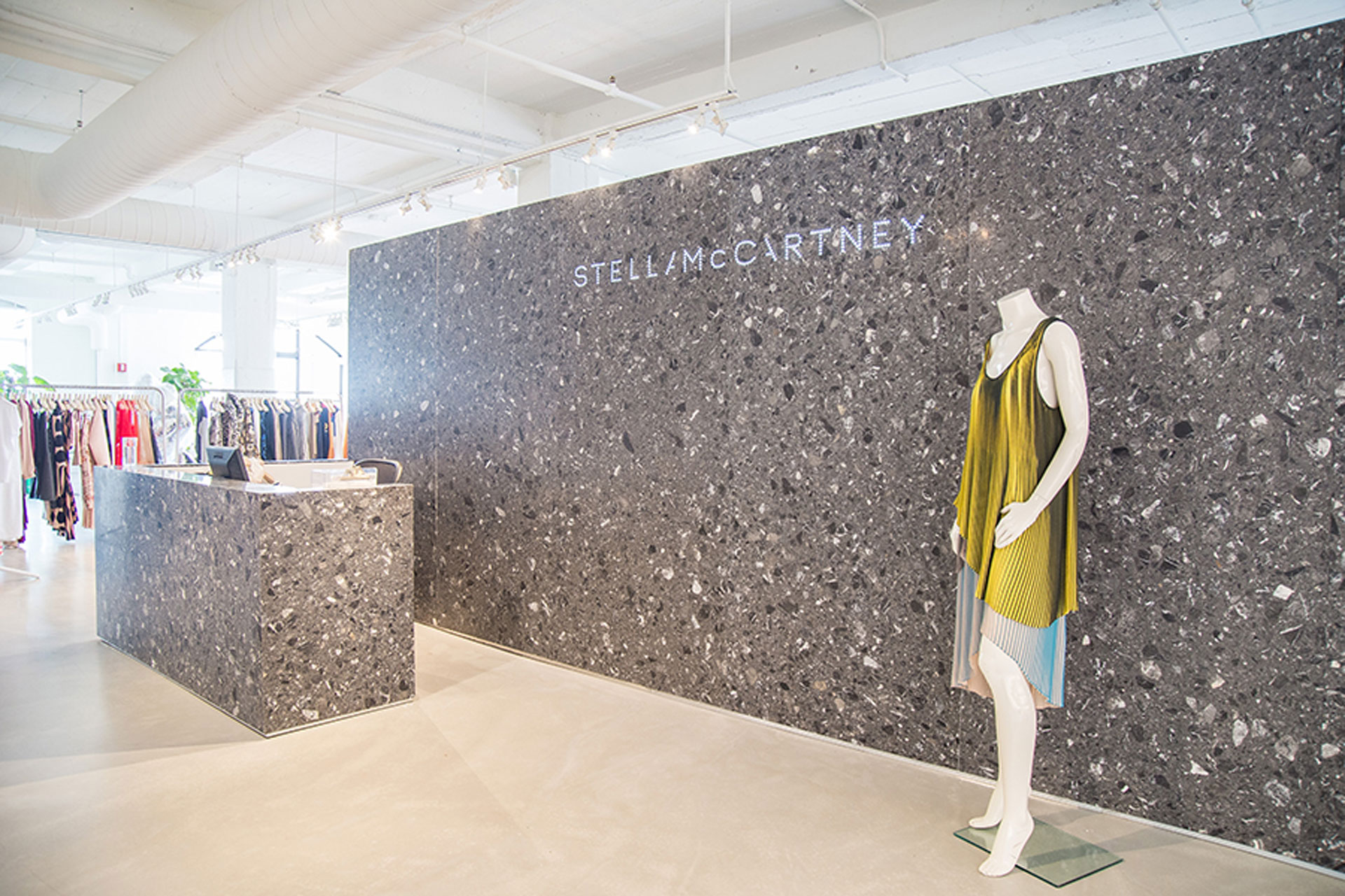 <p>The monolithic central stockroom and reception desk is covered with a stone cladding finish. </p>
