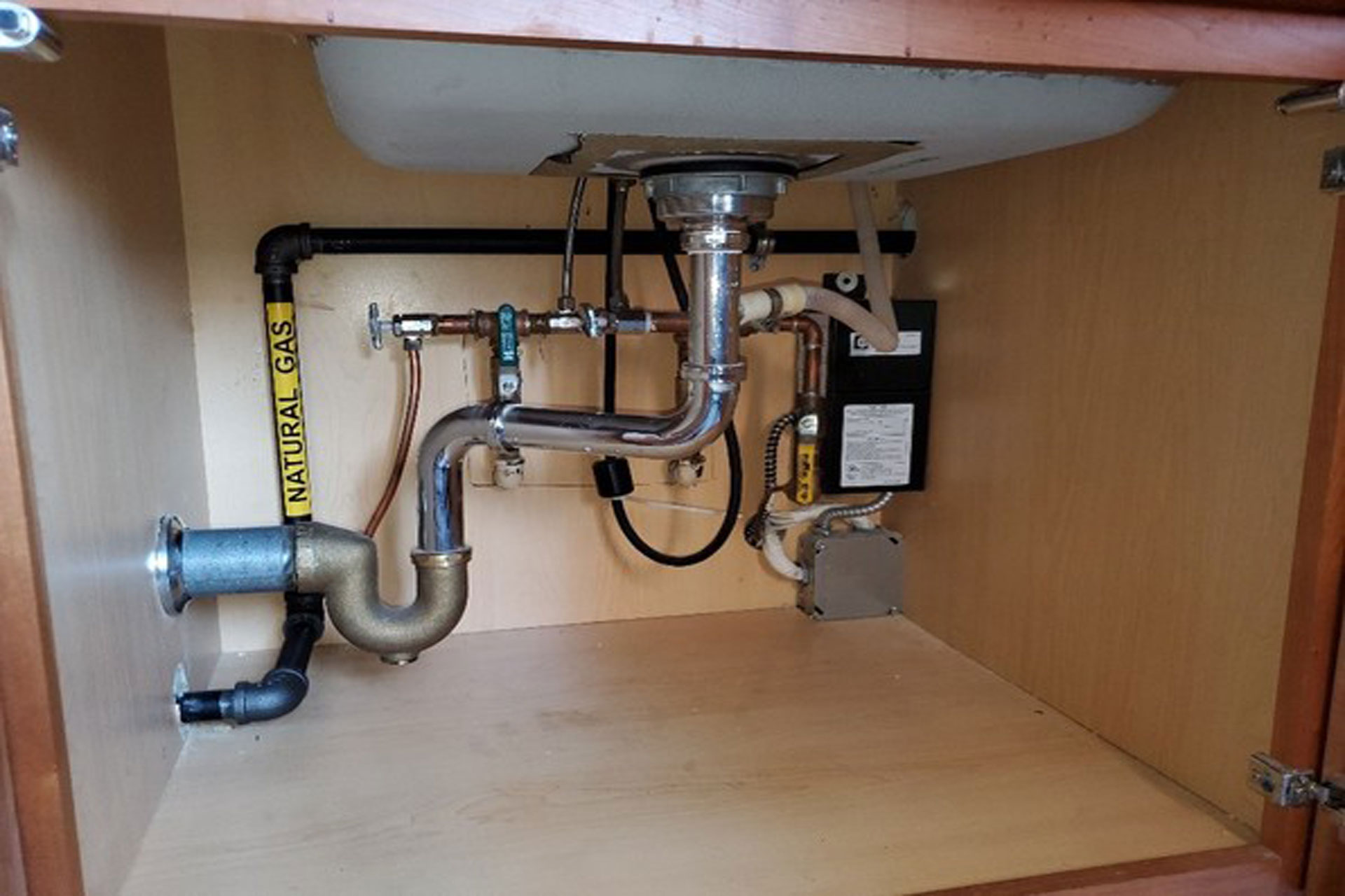 <p>New gas branch piping was run through kitchen cabinetry to reduce demolition costs or costs associated with removing countertops and cabinetry and putting them back in place.</p>
