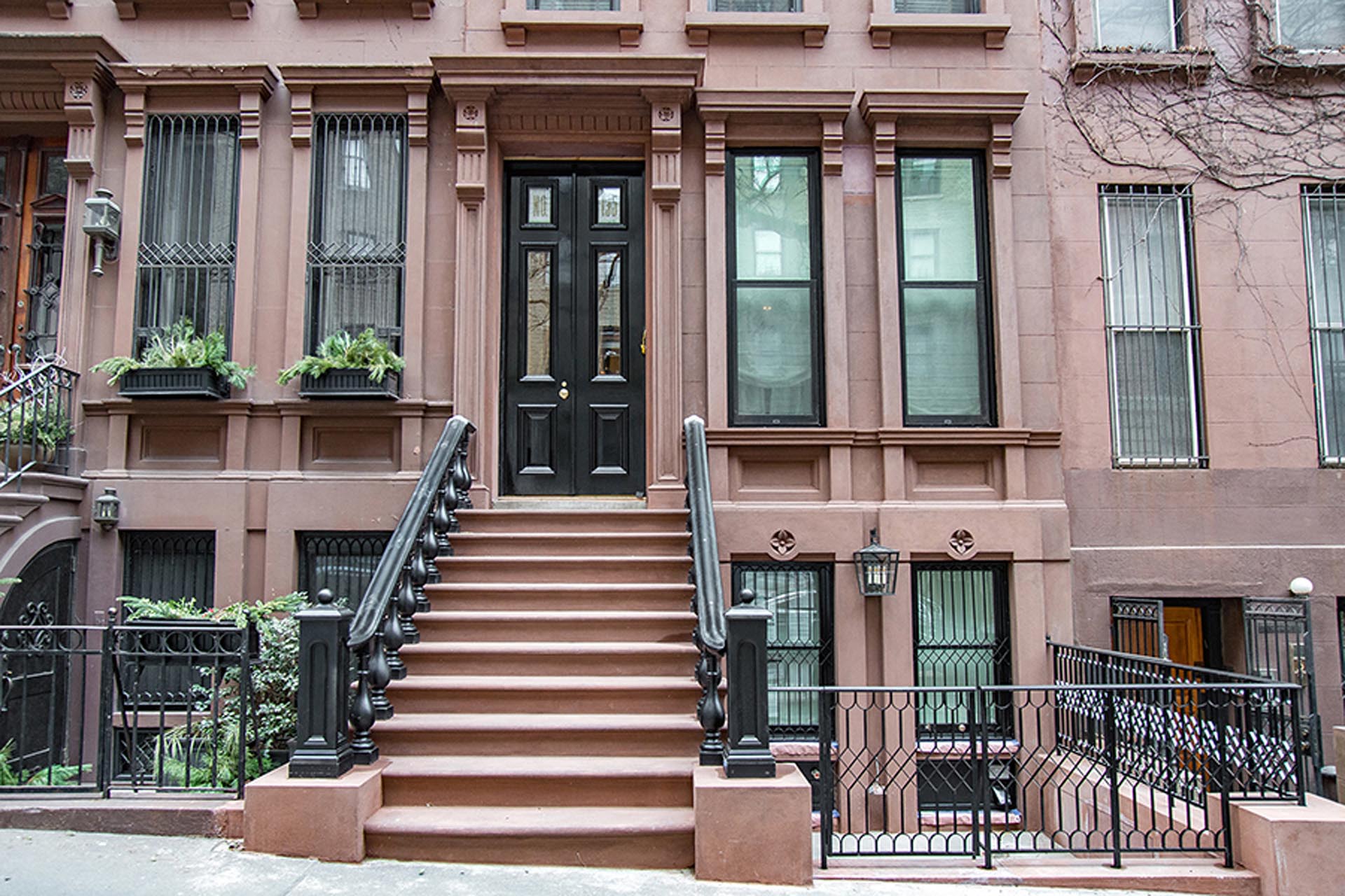 <p>The stucco finish was removed and new brownstone repair mortar replicating the historic texture, color, profile, and decorative features was applied.</p>
