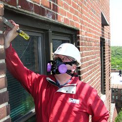 A Rand employee doing an asbestos survey