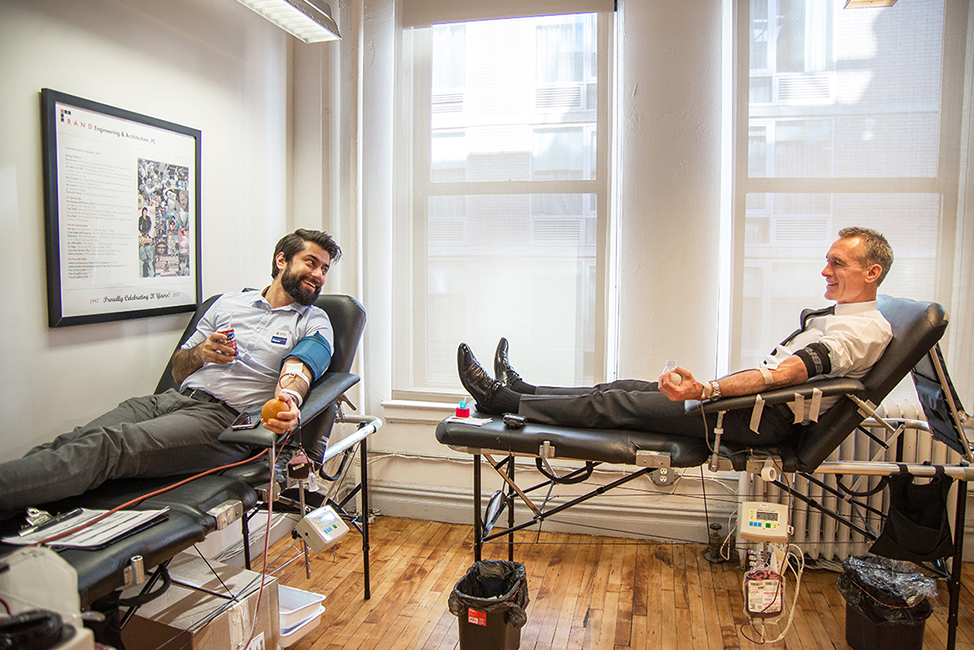 Power Red donor Eugene Gurevich, PE and whole blood donor, RAND's Business Development Director Peter Scallion chat while donating. 