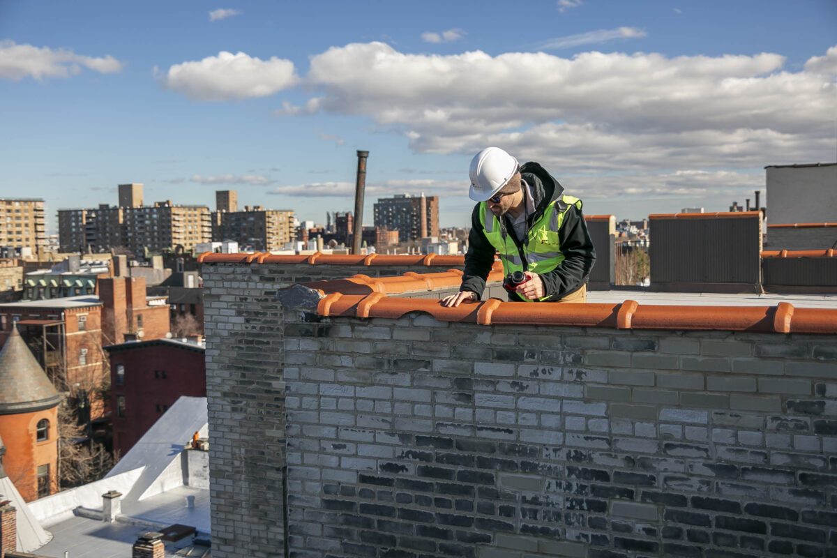 Engineering conducting a parapet inspection per New York City's new annual parapet inspection requirement.