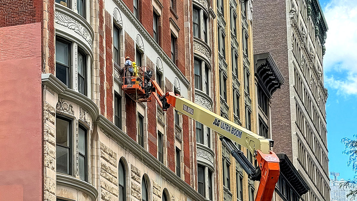 Facade Inspection Safety Program (FISP) inspection by boom lift.